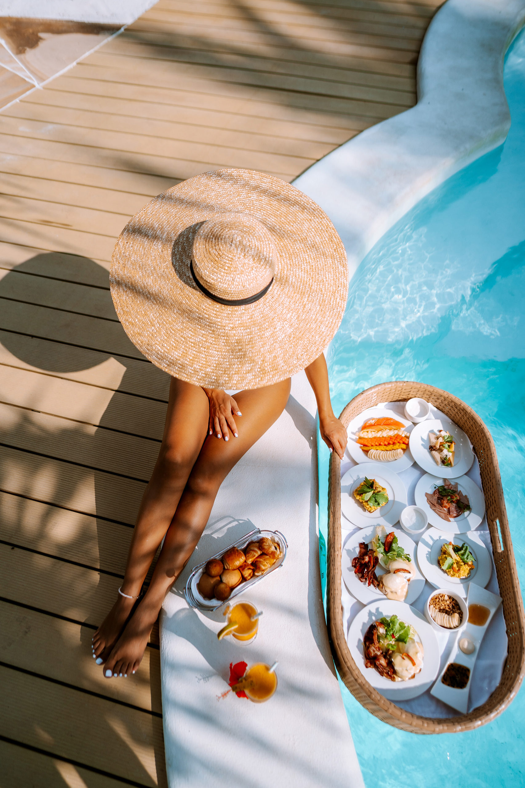 a lady having breakfast by the pool